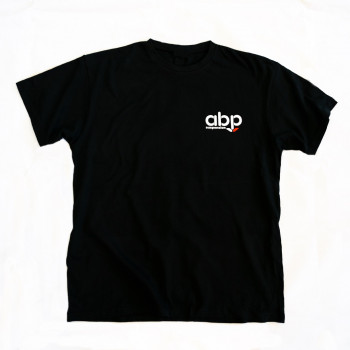 A black T-shirt featuring a small logo on the left chest area that reads "abp" in white text with a red arrow beneath it. The background is plain white.