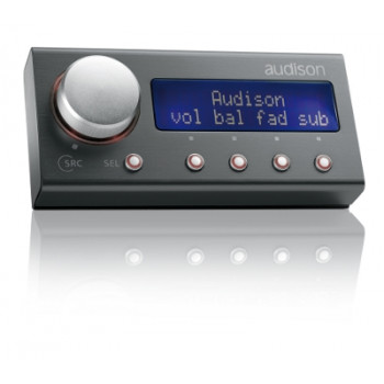 A digital audio control panel with a large silver knob, five buttons, and a blue display showing "Audison vol bal fad sub," reflects on a glossy surface.