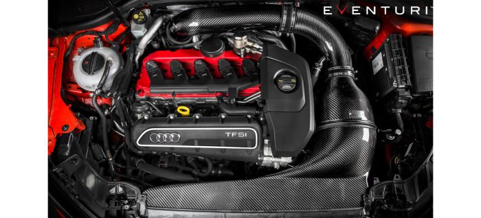 A high-performance car engine from Audi, featuring a red engine cover with "TFSI" and Audi logo, outfitted with Eventuri carbon fiber intake system, in a black/red engine bay. "EVENTURI" is written in the top right corner.