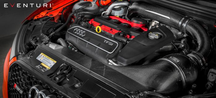 An Audi TFSI engine with a bright red intake manifold and "EVENTURI" branded carbon-fiber air intake system, housed inside a car's engine bay with a black and orange exterior.