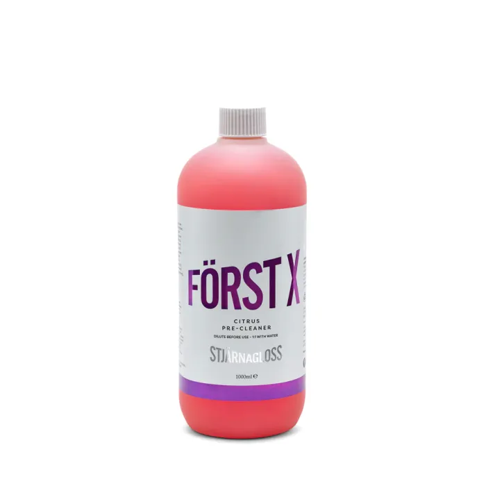 A red bottle with a white label and purple text stands against a plain white background. The label reads: "FÖRST X, Citrus Pre-Cleaner, dilute before use - 1:1 with water, STJÄRNAGLOSS, 1000ml e".