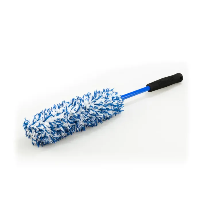A blue and white microfiber duster with a black handle lies on a plain white surface.