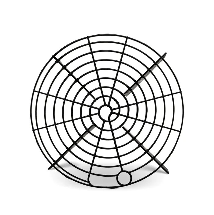 A black, round cooling rack with a grid pattern stands upright against a white background.
