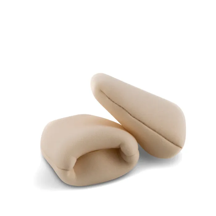 Two beige, foam wine bottle protectors are lying on a white surface, one open and one closed, designed to safeguard wine bottles during transport.