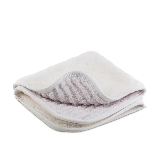 A folded, white fluffy towel with visible thick, soft fibers and stitched edges, placed on a plain white background. The interior texture appears ribbed, revealing its plush and cozy material.