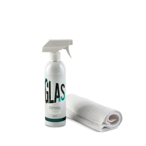 A white spray bottle labeled "GLAS Professional Glass Cleaner Stjärngloss" stands beside a folded white cleaning cloth against a white background.