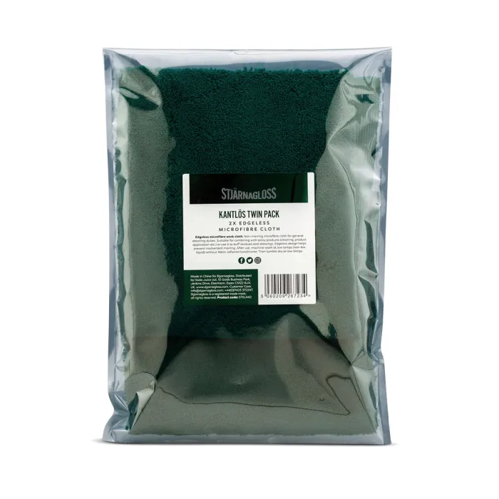 Plastic-wrapped pack containing two green microfiber cloths. Label reads: "STJÄRNAGLOSS KANTLÖS TWIN PACK 2x EDGELESS MICROFIBER CLOTH." Additional text includes product description, care instructions, and barcode.