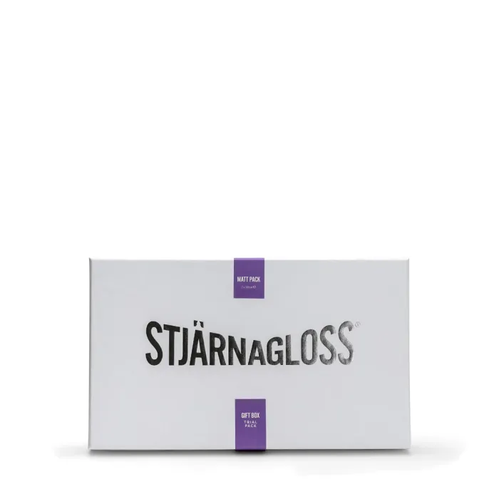 Rectangular white box labeled "STJÄRNAGLOSS" with purple tags reading "MATT PACK" and "GIFT BOX TRIAL PACK," displayed against a plain white background.