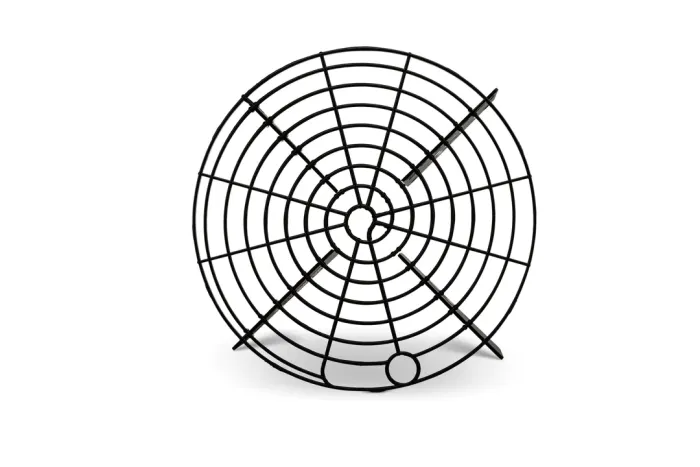 A black, circular metal cooling rack with concentric circles and radiating spokes stands upright on a white background.