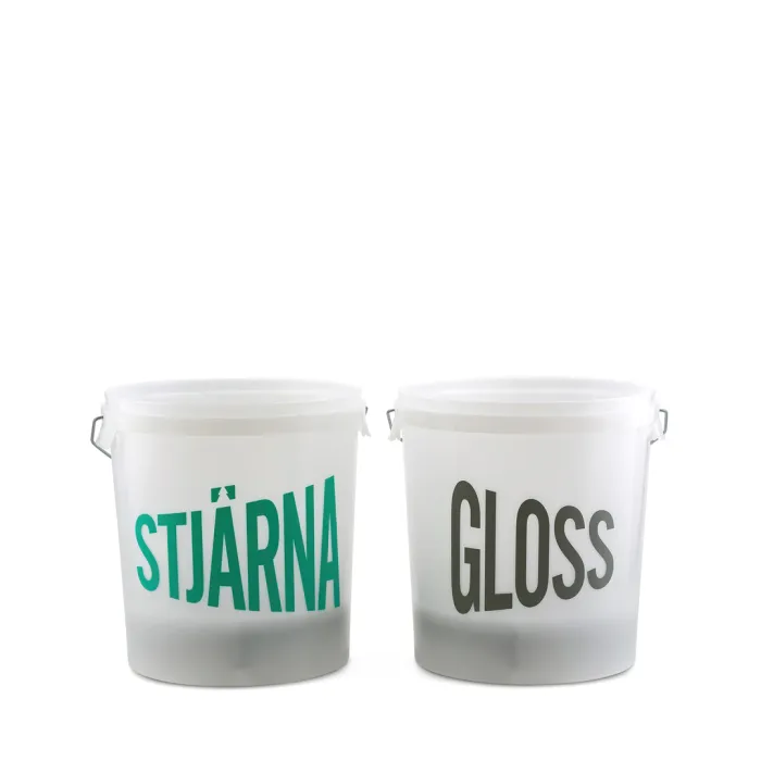 Two white plastic buckets with handles, labeled "STJÄRNA" in green on the left and "GLOSS" in gray on the right, are placed side by side against a plain white background.