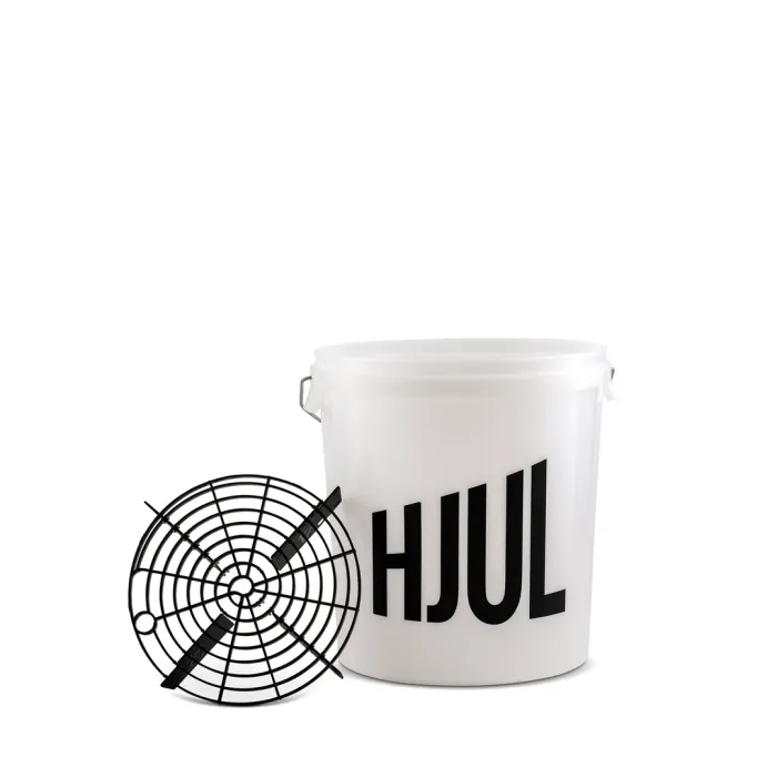 A white plastic bucket labeled "HJUL" is placed beside a black, circular grid insert, in a plain white background.