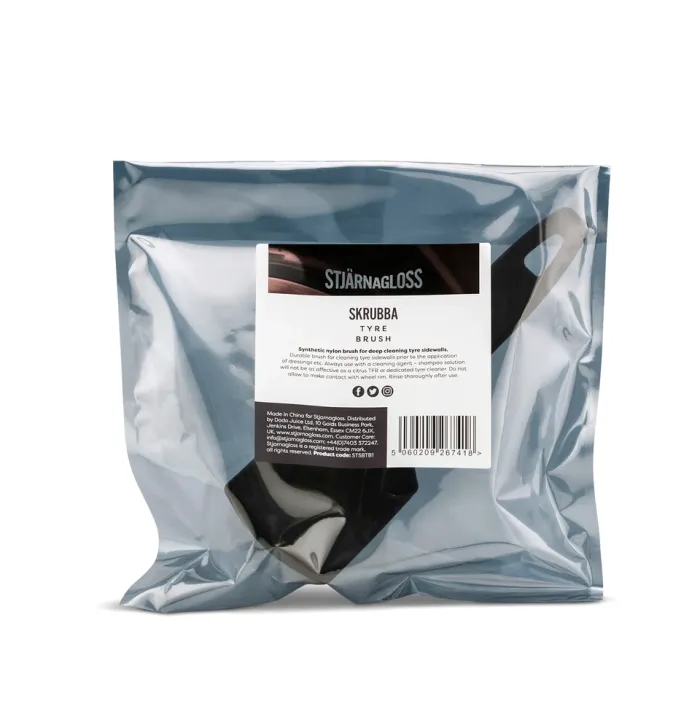 A black synthetic nylon brush is sealed in a transparent plastic bag labeled "STJÄRNAGLOSS SKRUBBA TYRE BRUSH," designed for deep cleaning tire sidewalls. The label includes detailed usage instructions and distributor information.
