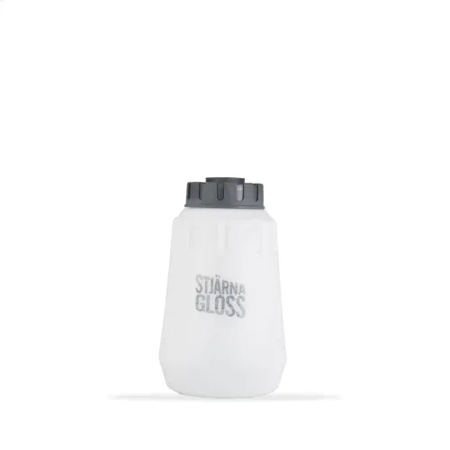 A white, translucent container with a gray screw cap, labeled "STJÄRNA GLOSS," sits isolated against a plain white background.