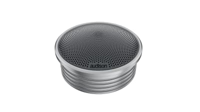 A round, metallic speaker with a perforated, circular grill design and "audison" written on the front; placed against a plain white background.