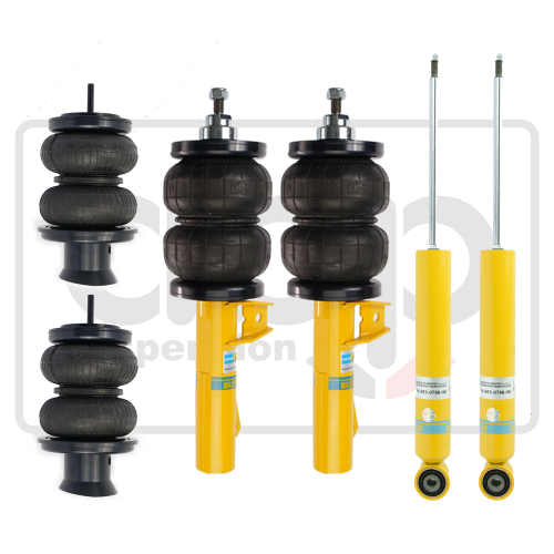 Four suspension components, including two black double-bellows air springs, two yellow shock absorbers, and two air spring struts with yellow bases, arranged against a plain light background.