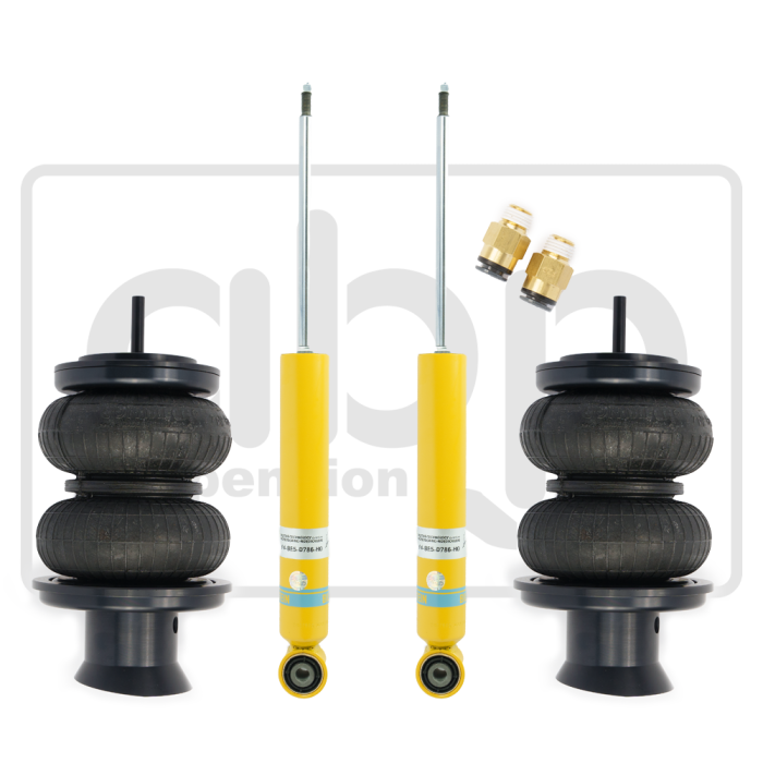 Two black air suspension bags and two yellow shock absorbers laid out on a white background with two brass connectors. Background contains a faint logo of “abc Suspension.”