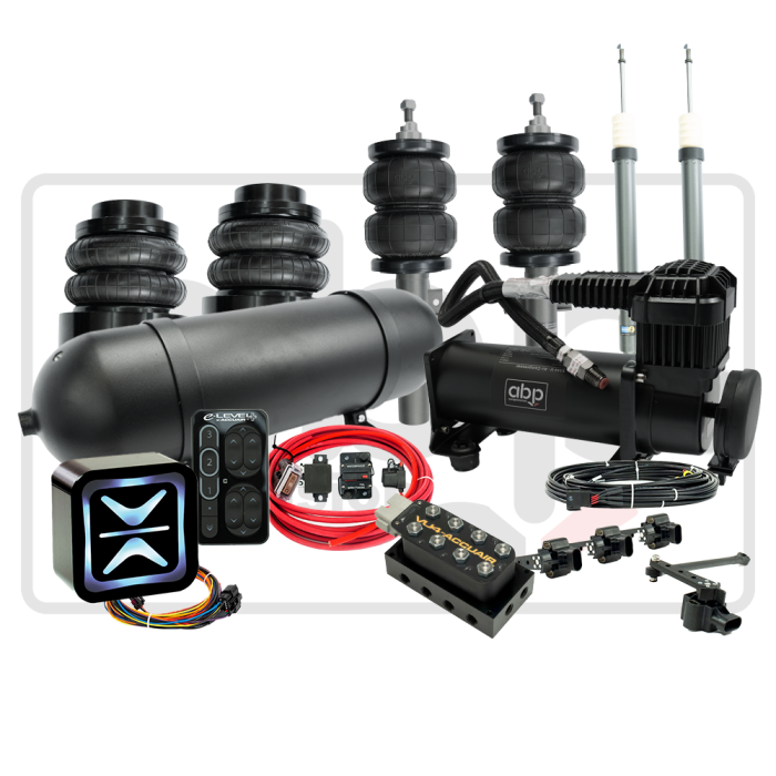 Air suspension kit with bags, compressor, manifold, remote, wiring, and shock absorbers against a plain background. Text on remote: "E LEVEL." Text on compressor: "abp." Text on manifold: "VIAIR."