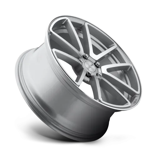 A metallic car wheel rim with a modern, multi-spoke design stands propped at an angle against a clean, white background. The text "ROHANA" is inscribed on the rim.
