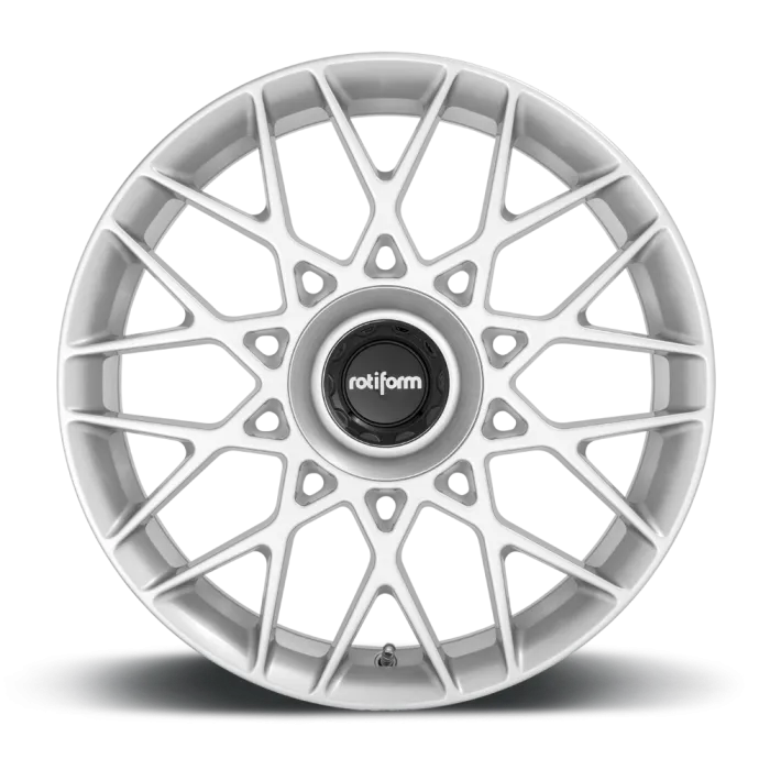 A white, multi-spoke alloy wheel with a central black cap labeled "rotiform," resting on a black surface against a plain background.