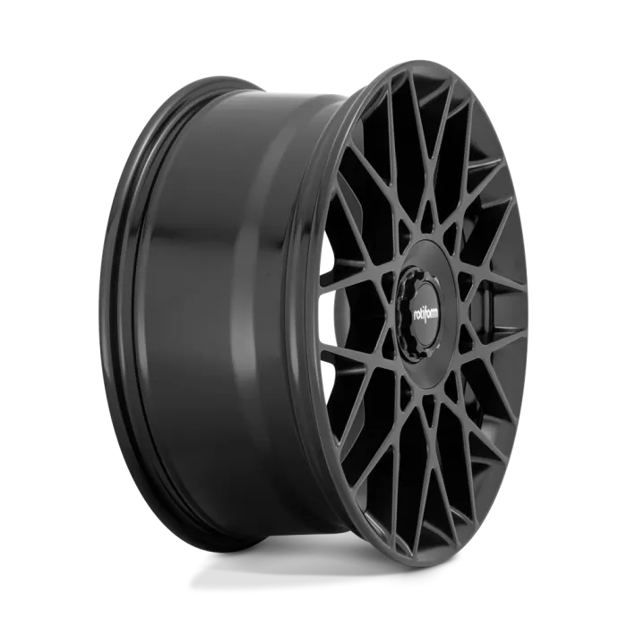A matte black wheel rim with a complex, geometric spoke design; "rotiform" is written on the center cap. There is a plain, light-colored background.