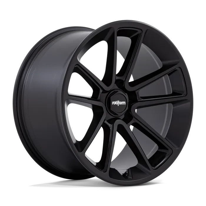 A black alloy wheel branded "rotiform" features an intricate, multi-spoke design, resting at an angle against a plain, black background.
