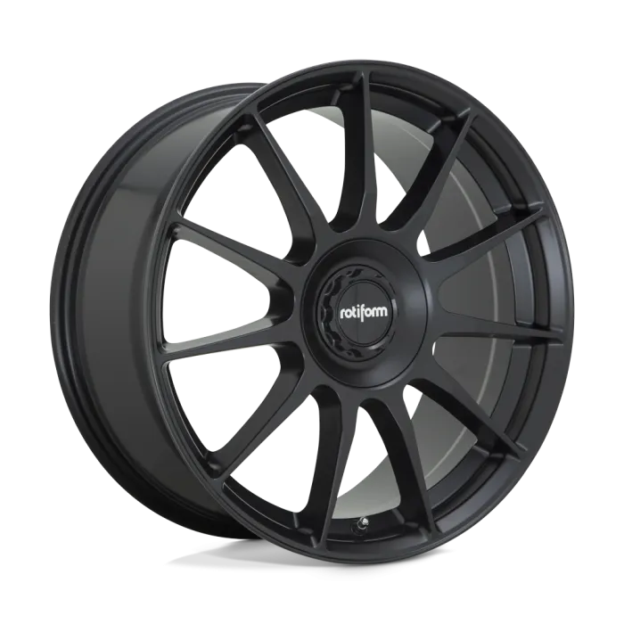 A black Rotiform alloy wheel featuring a multi-spoke design and a central hub with the "rotiform" logo, standing upright against a white and gray gradient background.