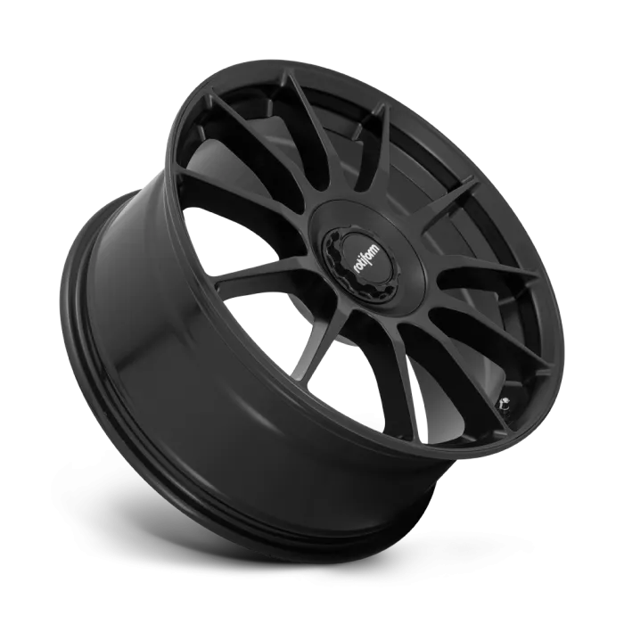 A black, ten-spoke car wheel rim is angled slightly to the right against a plain background. The center cap features the logo "rotiform."