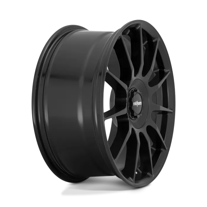 A black, multi-spoked aluminum car wheel rim with the brand name "rotiform" at the center; it stands upright against a plain white background.