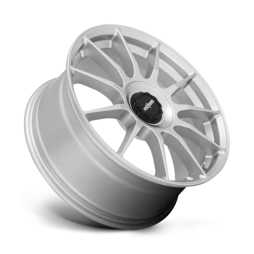 Silver alloy wheel, featuring multiple V-shaped spokes and a central black hub reading "rotiform," appears angled in a studio setting against a plain background.
