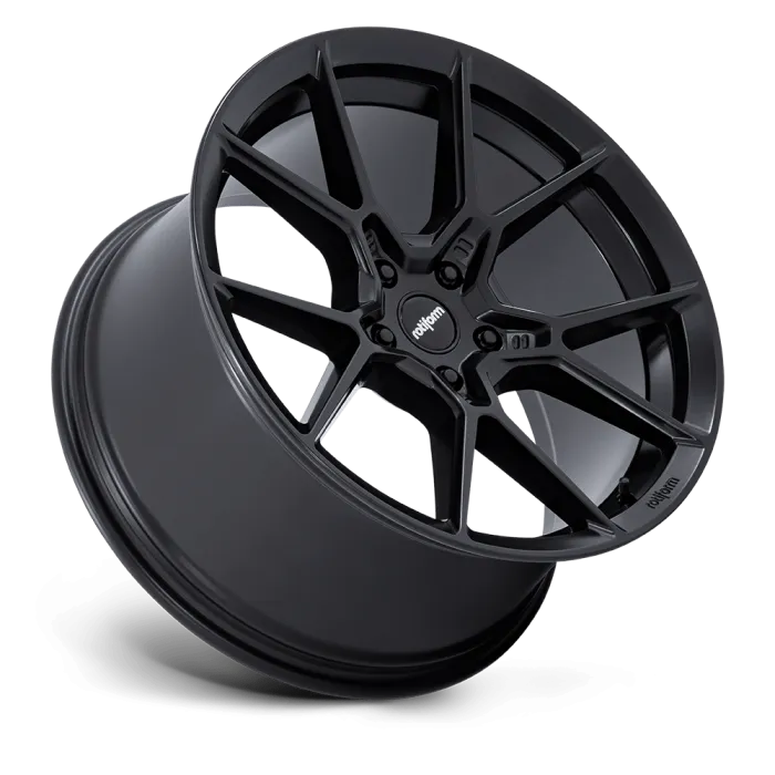 A black alloy car wheel displayed against a plain background, featuring a multi-spoke design with the word “rotiform” on the center cap and spokes.
