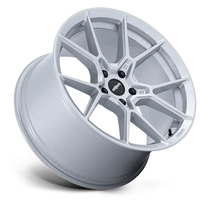 A silver, multi-spoke car wheel rim positioned at an angle, floating against a plain black background. The center cap displays the text "rotiform."
