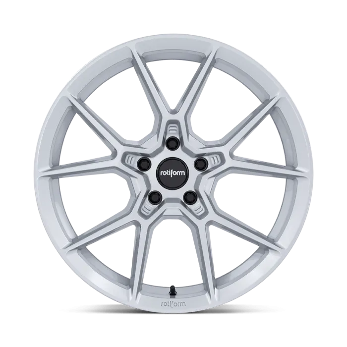 A silver, multi-spoke automotive wheel standing upright against a black background. The wheel features the text "rotiform" prominently on the center cap and the rim.