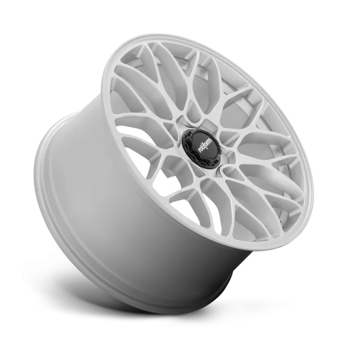 A white alloy wheel with intricate, overlapping spokes is displayed against a plain background. The center cap features the text "rotiform" on a black surface.
