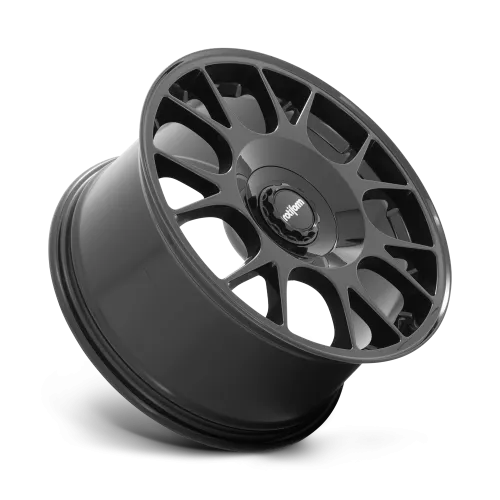 A black alloy wheel with an intricate multi-spoke design rests against a plain background; the central cap features the word "rotiform."