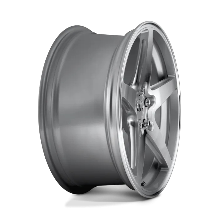 A silver, five-spoke alloy wheel with a polished finish lies against a neutral gray background. The wheel features a central hub with visible lug nut holes and slight reflections on its surface.