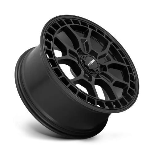 A black alloy wheel is angled upward, showcasing intricate spoke design with "Rotiform" on the center cap. The wheel is isolated against a white background.