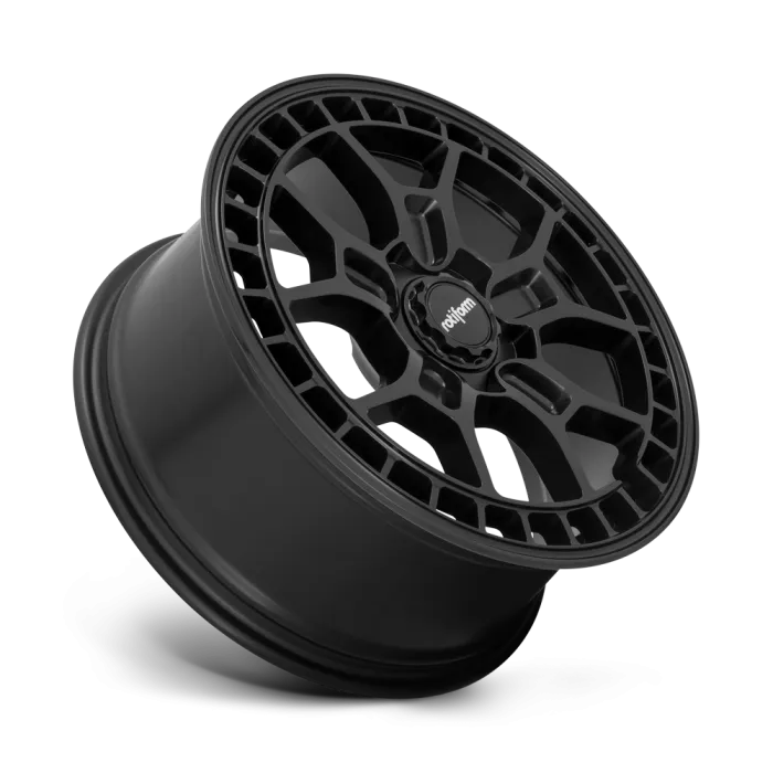 A black alloy wheel is angled upward, showcasing intricate spoke design with "Rotiform" on the center cap. The wheel is isolated against a white background.