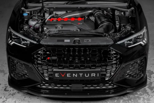 The front view of a black Audi RS3, hood open, showcasing the engine and carbon fiber air intake system with a prominent "EVENTURI" logo on the lower grille.