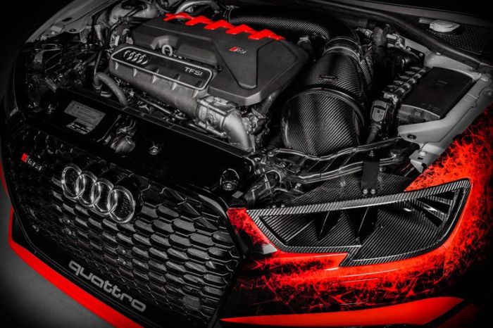 Audi Quattro engine with carbon fiber components is showcased under the hood, highlighted against a black background with red accents. The text visible includes "quattro," "TFSI," and the Audi logo.