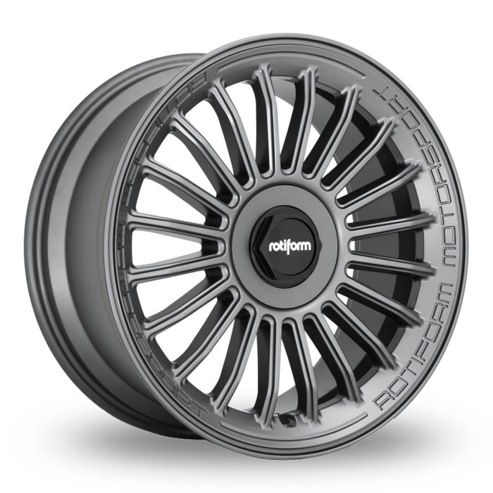 Dark grey car wheel rim with multi-spoke design. Center cap shows “rotiform” logo. Rim edge is engraved with “ROTIFORM MOTORSPORT.” Set against a plain, white background.