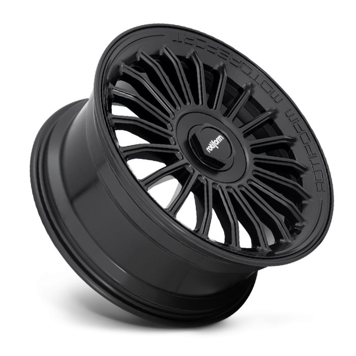 A black, multi-spoke alloy wheel rests at an angle, displaying the text "rotiform" on the center cap and "ROTFOM" along the rim in an isolated, white background.