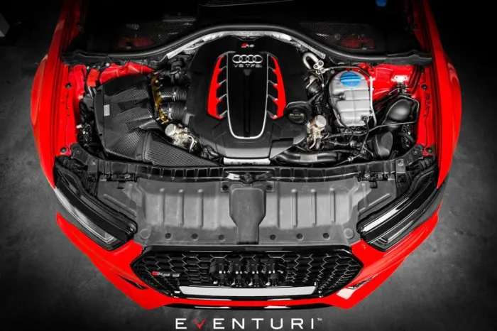Engine bay of a red car; the Audi V8T FSI engine is prominently positioned with the hood open. "EVENTURI" text is displayed at the bottom.