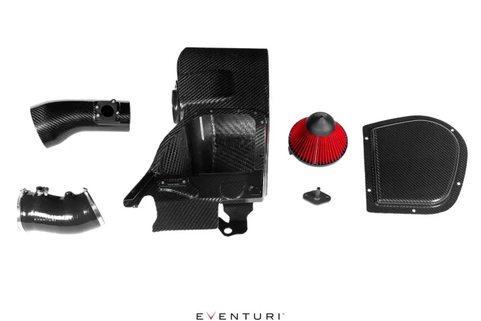 A carbon fiber car engine intake system with several components, including tubes, a red cone filter, and various covers, laid out against a white background. Text: "EVENTURI."