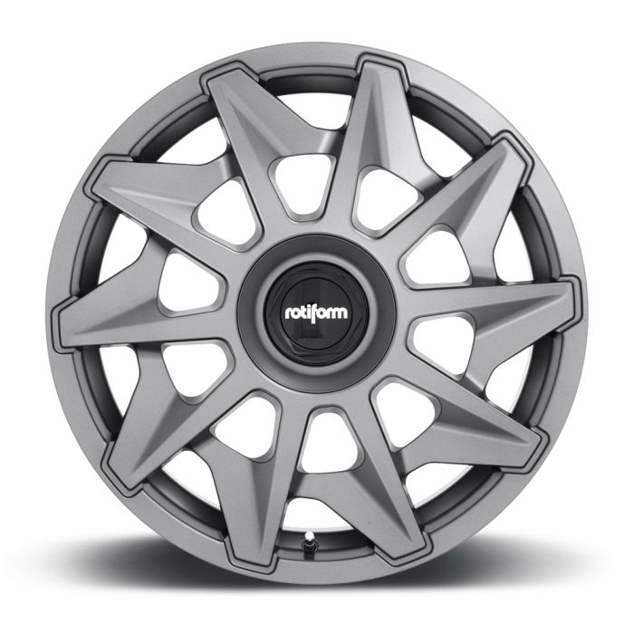 A silver alloy wheel with a star-shaped, multi-spoke design is resting on a neutral, white background. The central cap features the text "rotiform".