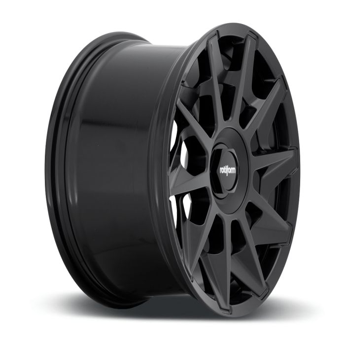 A black alloy wheel standing upright on a white background, featuring a multi-spoke design with the text "rotiform" on the center cap.