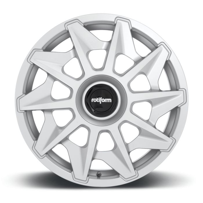 A silver alloy wheel featuring a starburst spoke design with a black center cap displaying the word "rotiform," positioned against a plain white background.