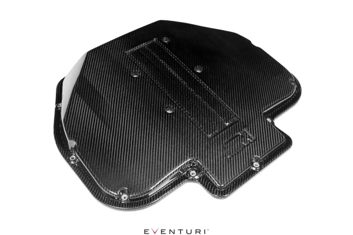 Black carbon fiber car engine cover with visible mounting screws and textured surface, lying on a white background. Text below reads "EVENTURI™."