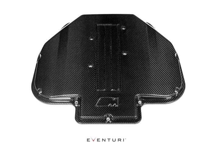 Dark carbon fiber engine cover with bolt holes and embedded "M" logo, displayed on a white background with "EVENTURI™" text beneath.
