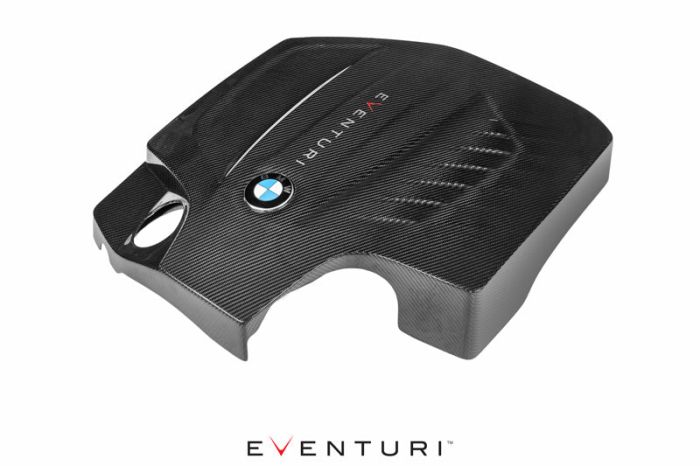 A black, carbon fiber engine cover with a BMW logo and "EVENTURI" text, displayed against a white background. (EVENTURI text repeated underneath the image).