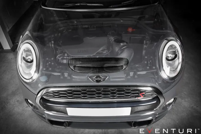 A Mini Cooper car with the hood partially transparent reveals the engine, parked inside a garage. Eventuri logo and text at the bottom right.